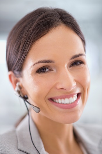 woman smiling at camera with a headset on